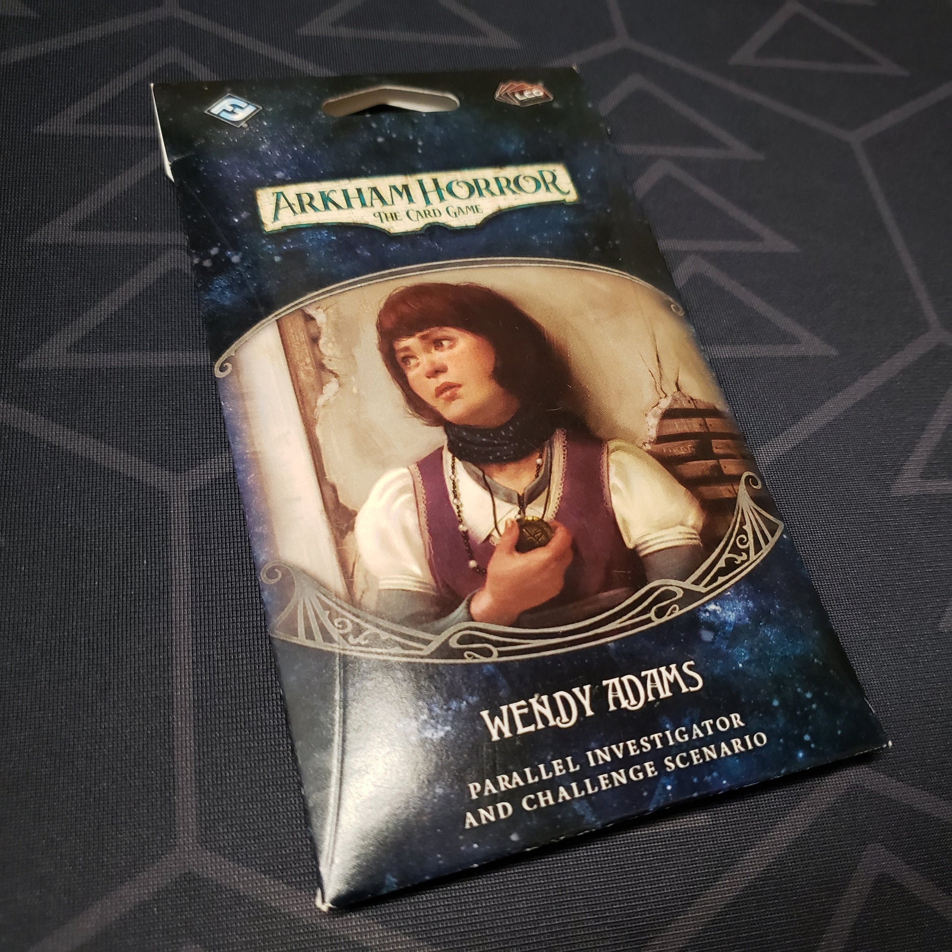 Image shows the front of the packaging of the Wendy Adams Parallel Investigator & Challenged Scenario expansion for Arkham Horror: The Card Game