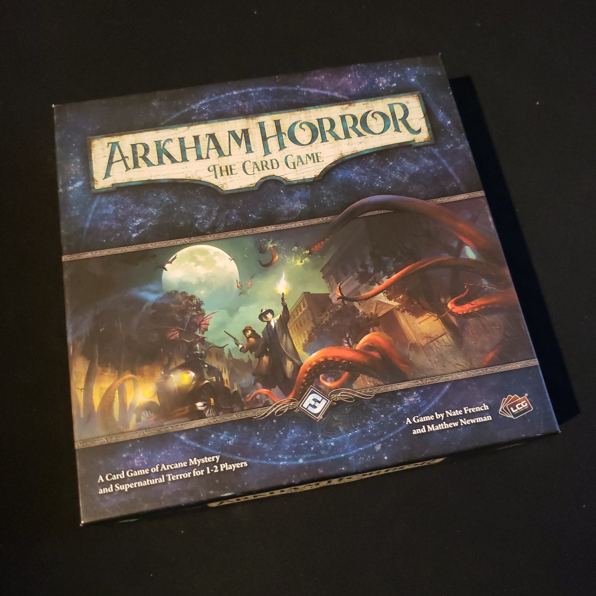 Image shows the front cover of the box of Arkham Horror: The Card Game