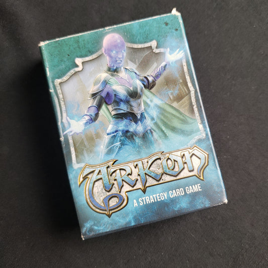 Image shows the front cover of the box of the Arkon card game