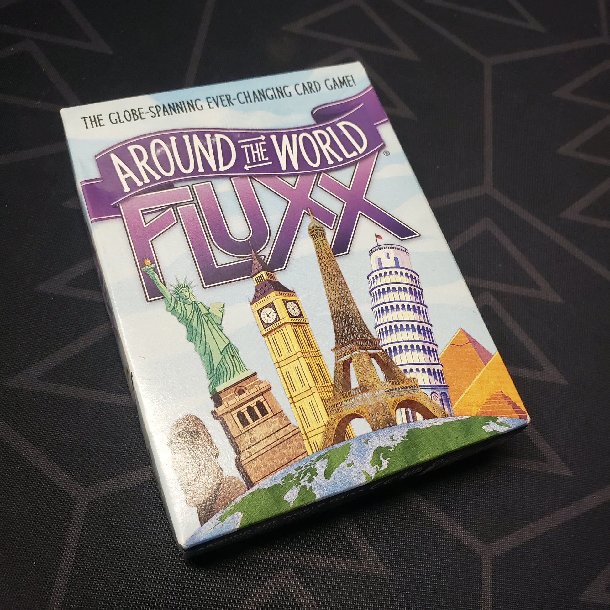 Image shows the front cover of the box for the Around the World Fluxx card game