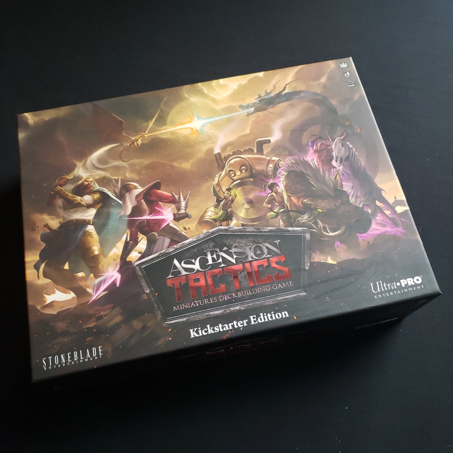 Image shows the front cover of the box of the Kickstarter Edition of the board game Ascension Tactics