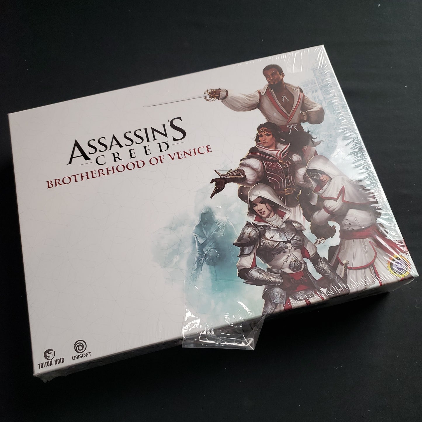 Image shows the front cover of the box of the Assassin's Creed: Brotherhood of Venice board game