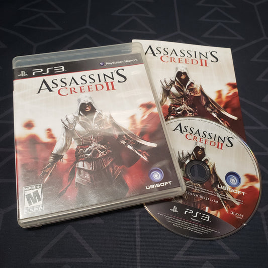 Image shows the case, manual and disc for the video game Assassin's Creed II for Playstation 3