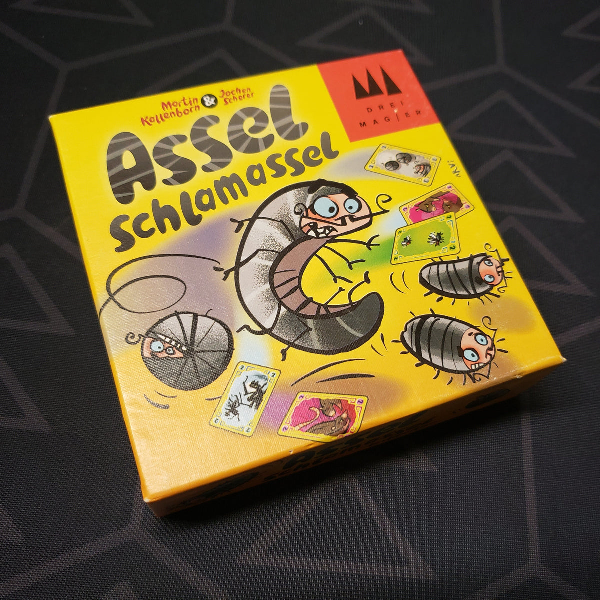 Image shows the front cover of the box for the Assel Schlamassel card game