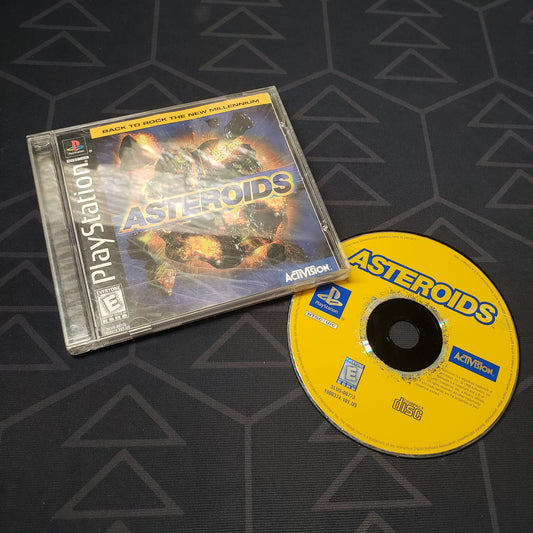 Image shows the jewel case with manual and disc for the video game Asteroids for Playstation 1