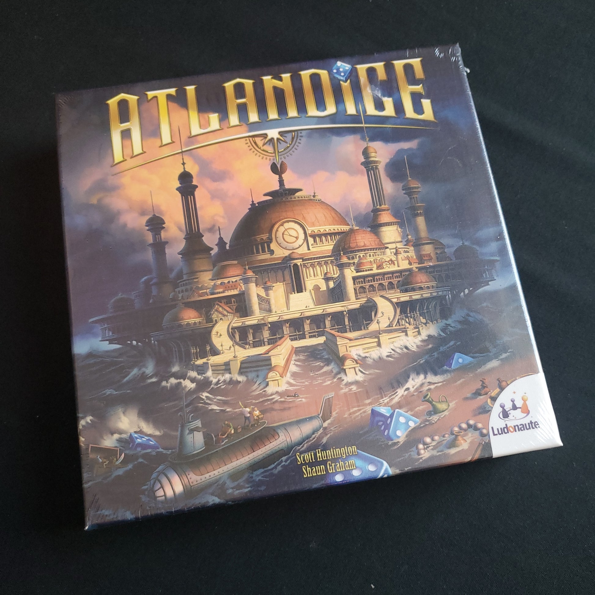 Image shows the front cover of the box of the Atlandice board game