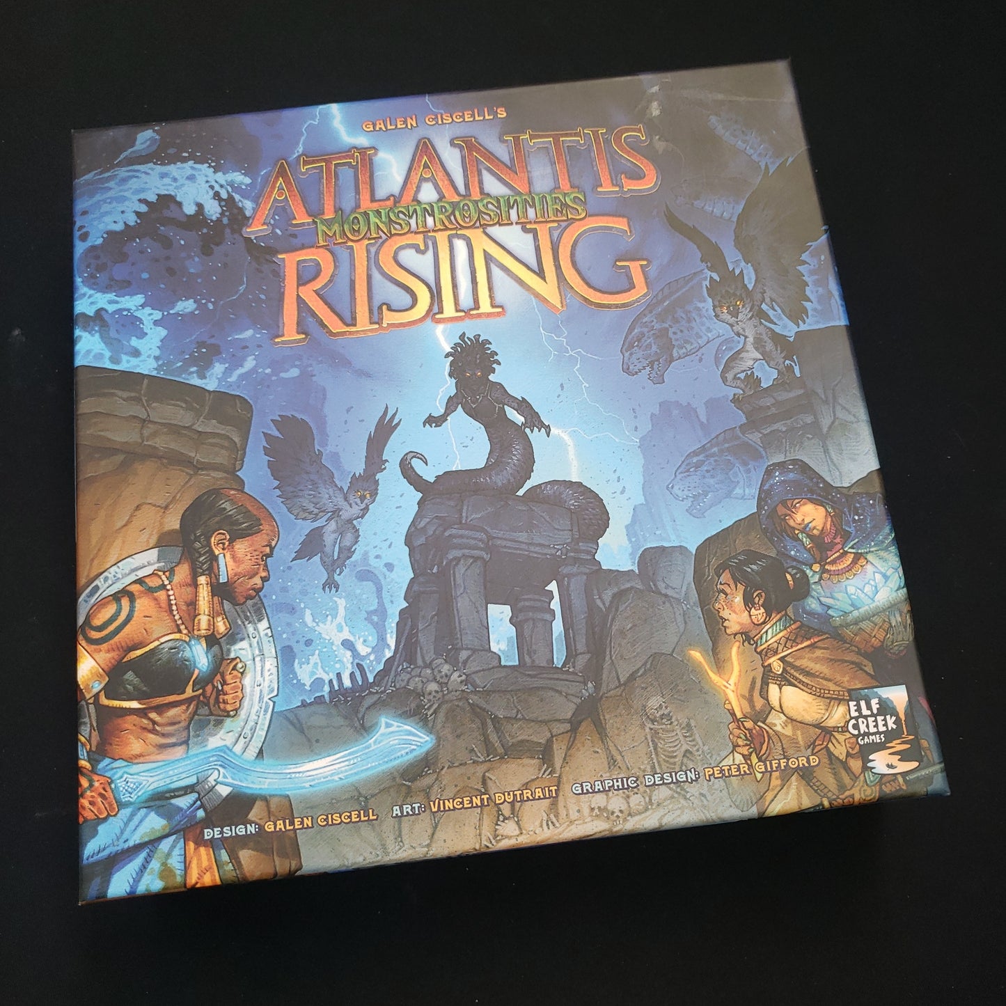 Image shows the front cover of the box of the Monstrosities expansion for the board game Atlantis Rising