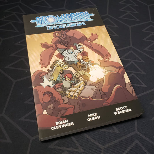 Image shows the front cover of the core rulebook for the roleplaying game Atomic Robo