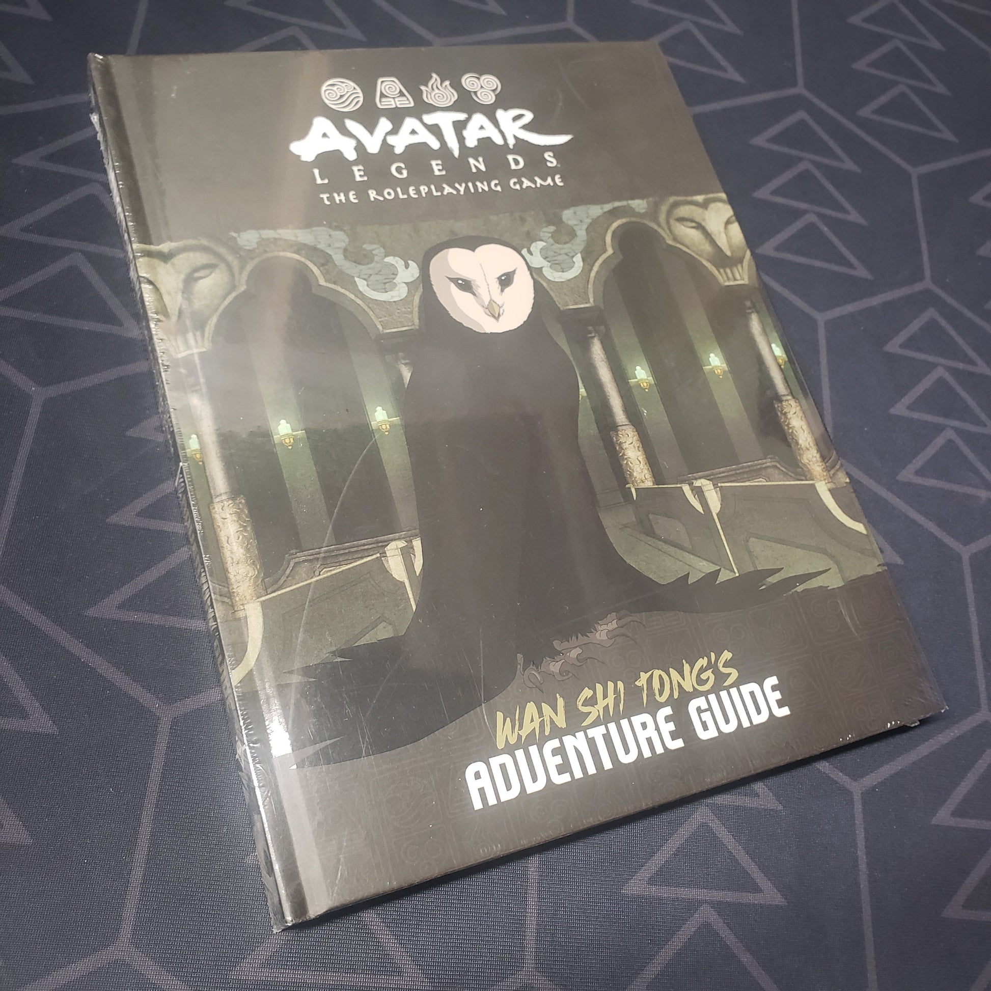 Image shows the front cover of the Wan Shi Tong's Adventure Guide book for the roleplaying game Avatar Legends