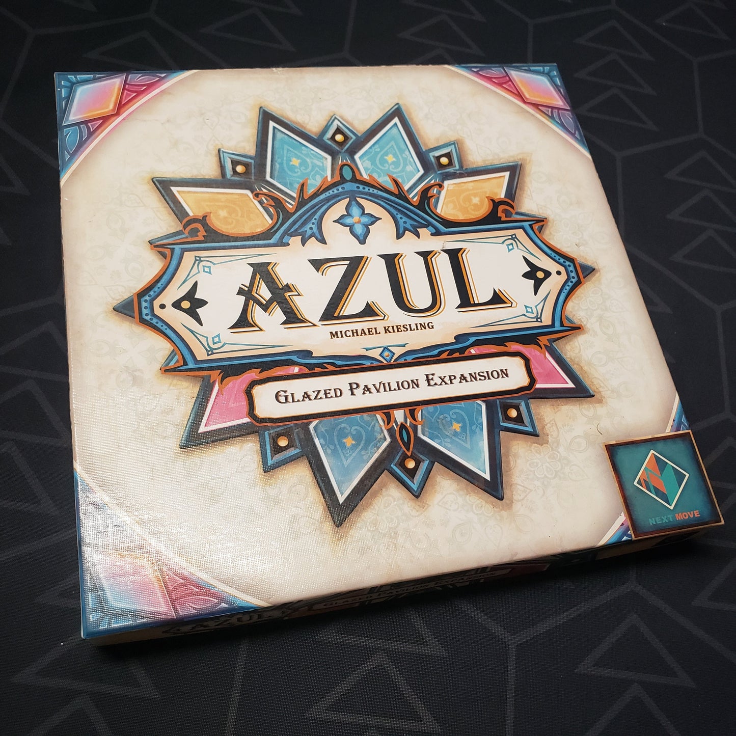 Image shows the front cover of the box of the Glazed Pavilion expansion for the board game Azul: Summer Pavilion