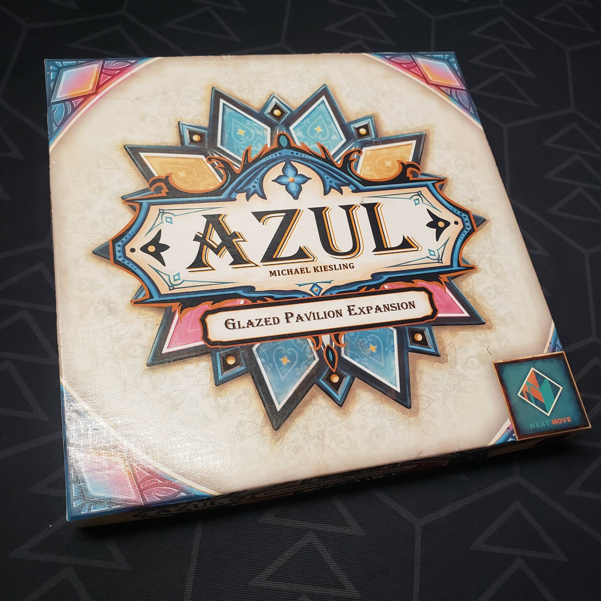 Image shows the front cover of the box of the Glazed Pavilion expansion for the board game Azul: Summer Pavilion