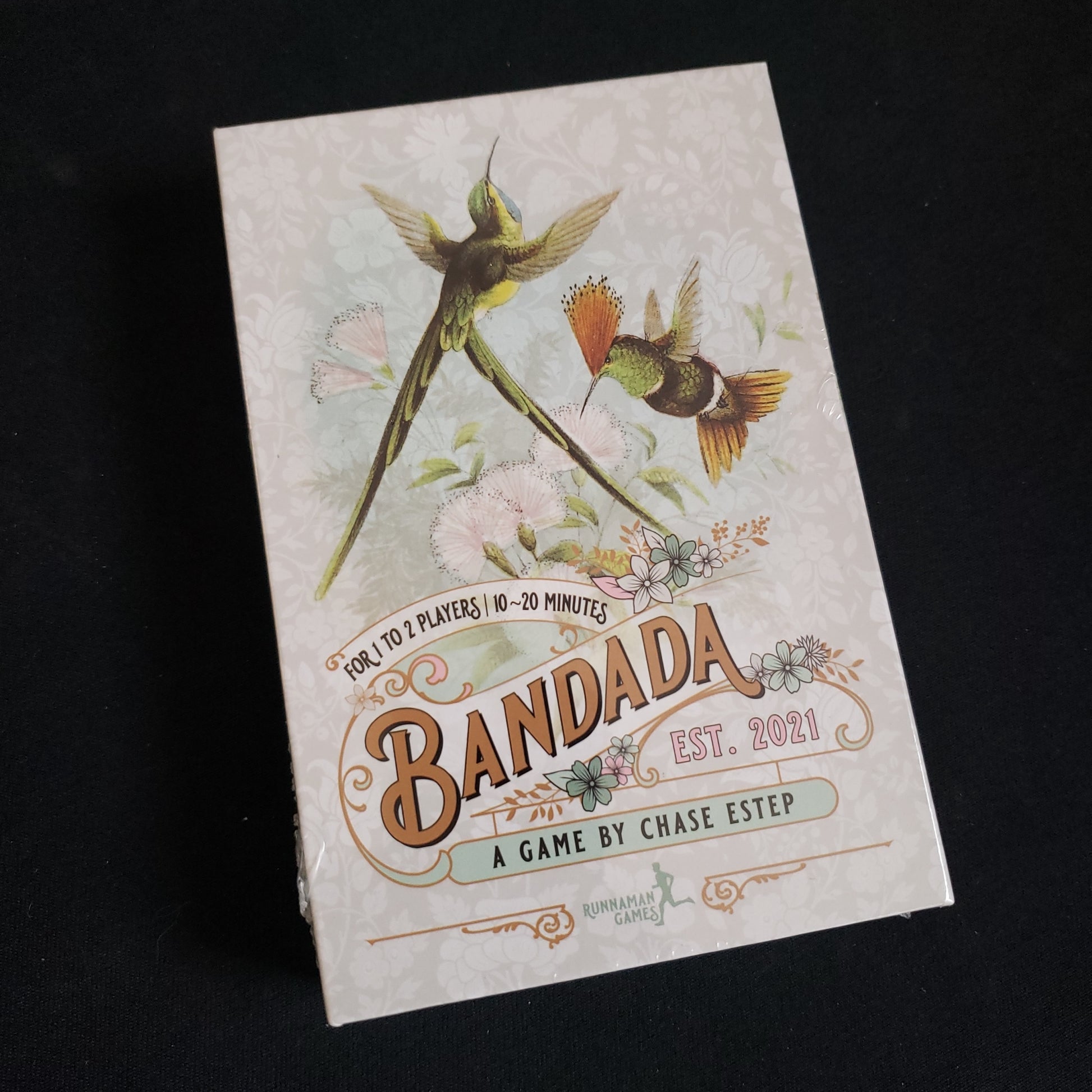 Image shows the front cover of the box of the Bandada card game