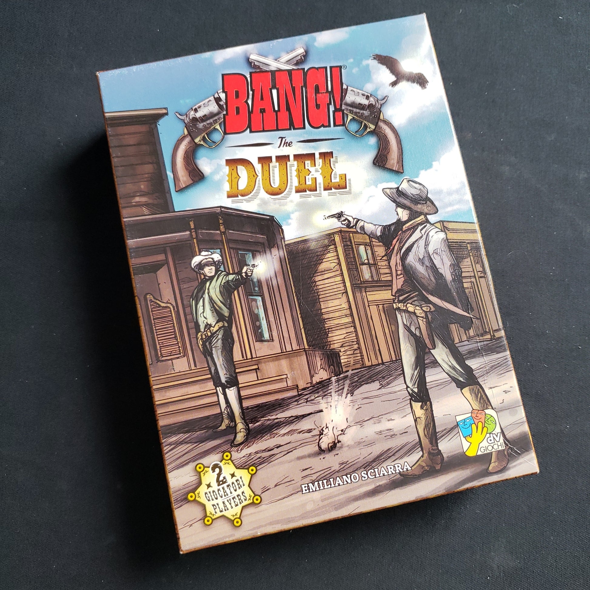 Image shows the front cover of the box of the BANG! The Duel card game