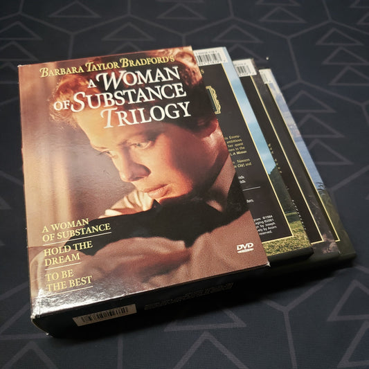 Image shows the outer box & three fanned-out disc cases for the miniseries  box set of Barbara Taylor Bradford's A Woman of Substance Trilogy on DVD