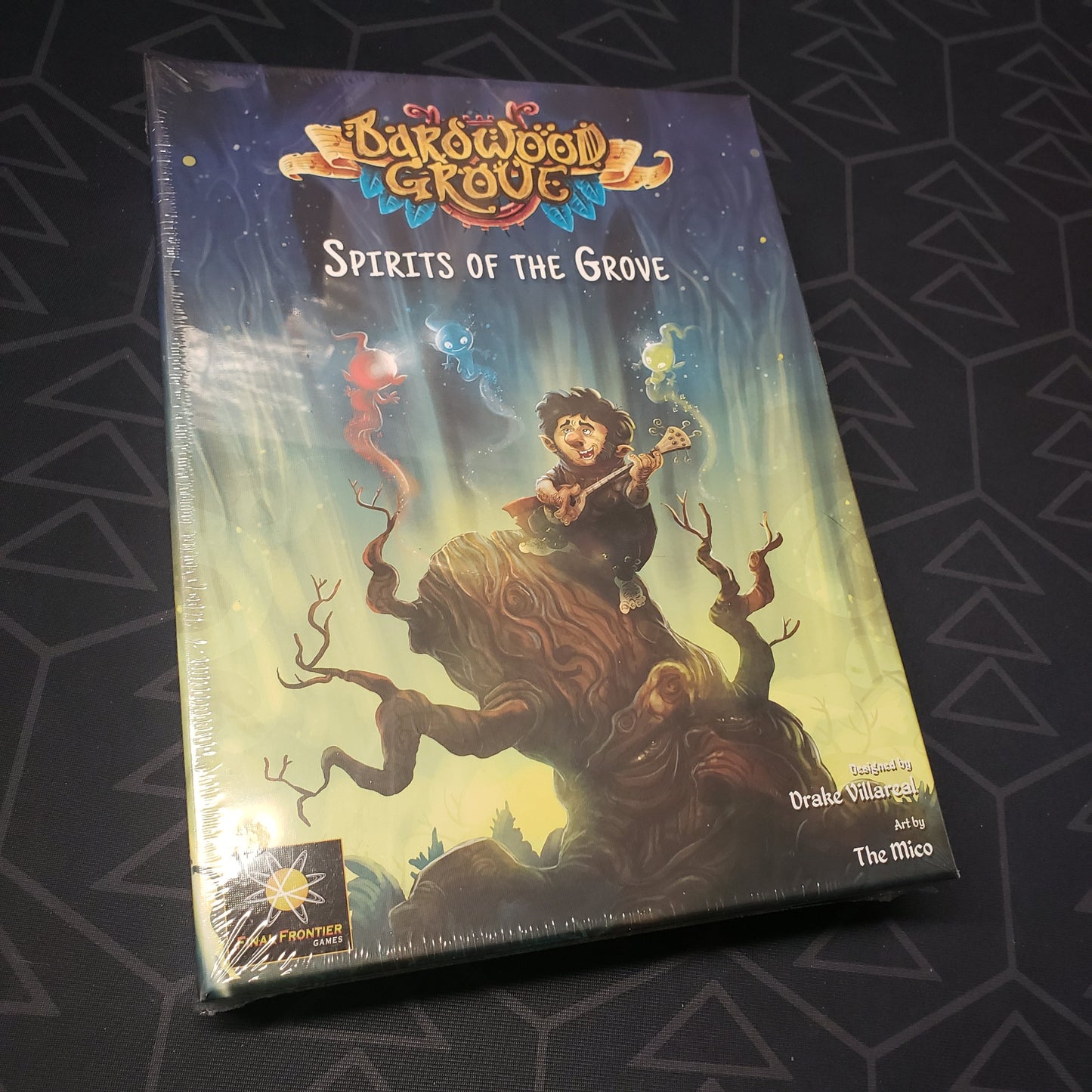 Image shows the front cover of the box of the Spirits of the Grove expansion for the board game Bardwood Grove