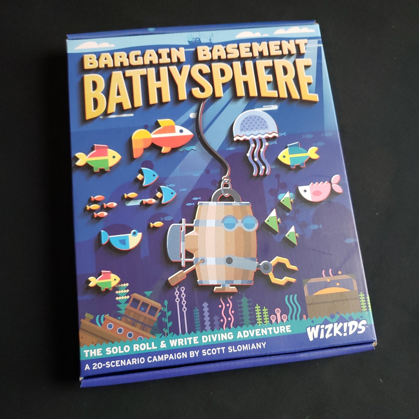 Image shows the front cover of the box of the Bargain Basement Bathysphere board game