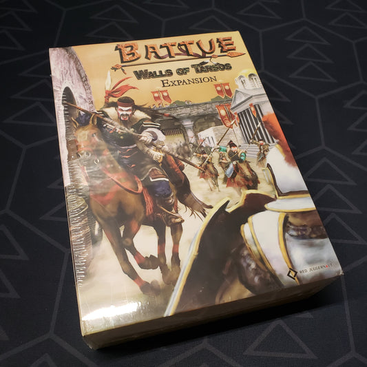 Image shows the front cover of the box of the Walls of Tarsos expansion for the board game Battue