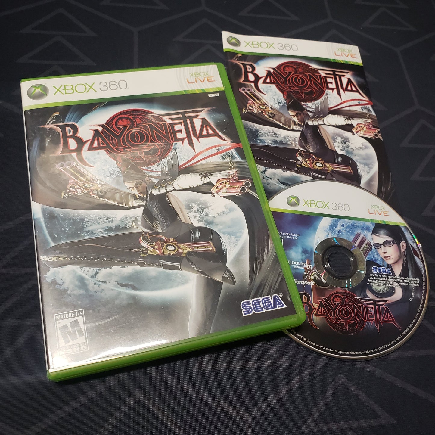 Image shows the case, manual and disc for the video game Bayonetta for Xbox 360
