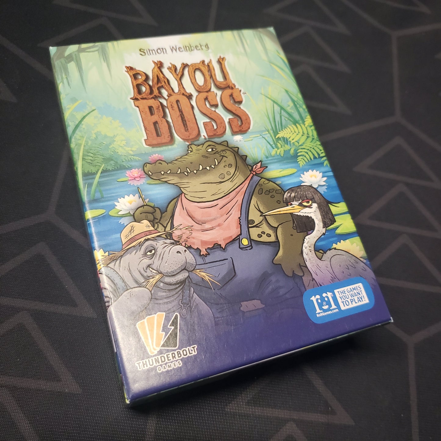 Image shows the front cover of the box for the Bayou Boss card game