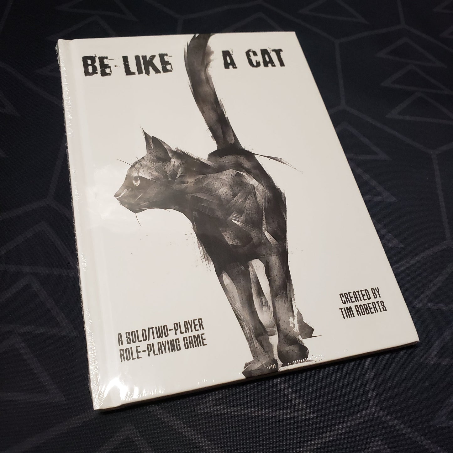 Image shows the front cover of the Be Like a Cat roleplaying game book