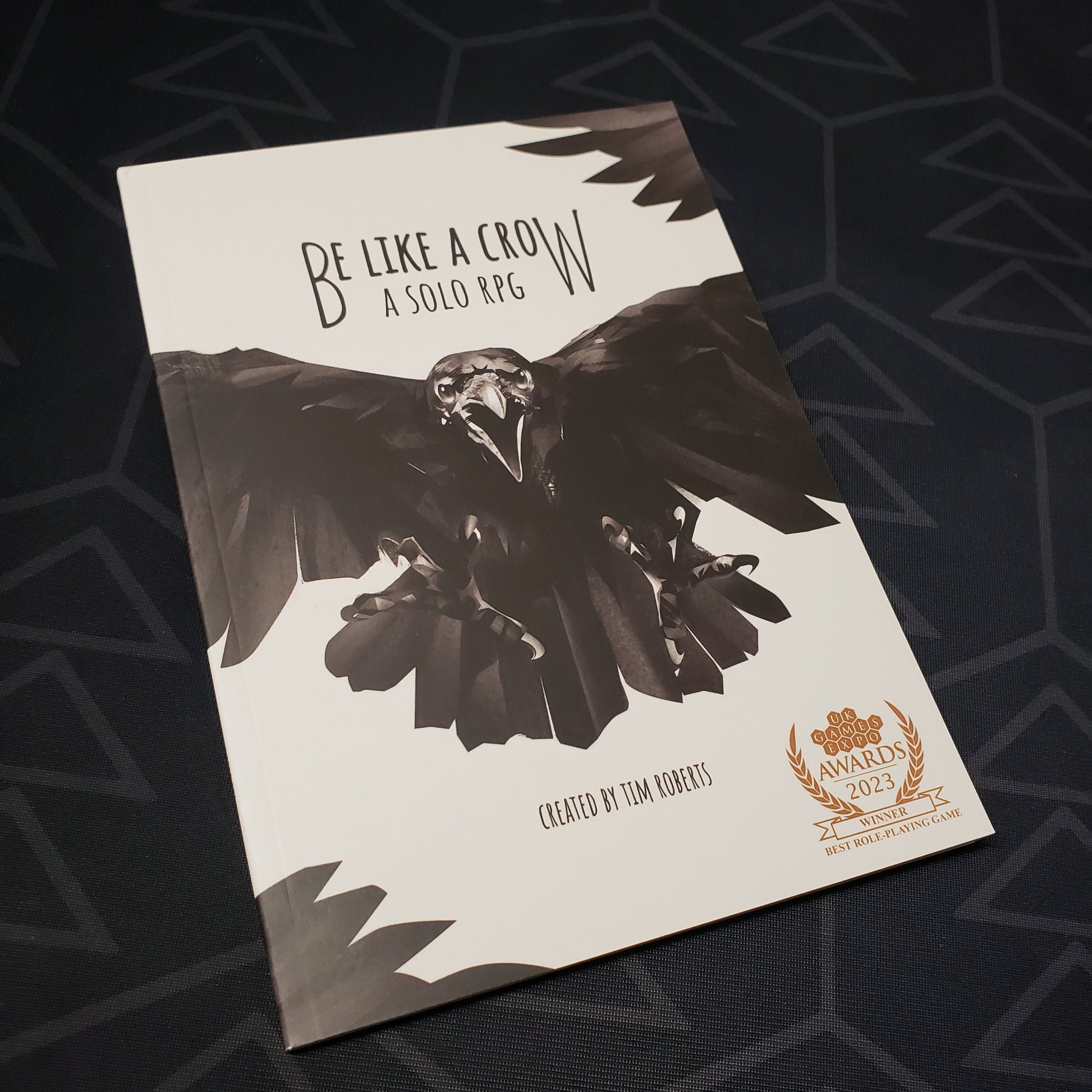 Image shows the front cover of the Be Like a Crow roleplaying game book