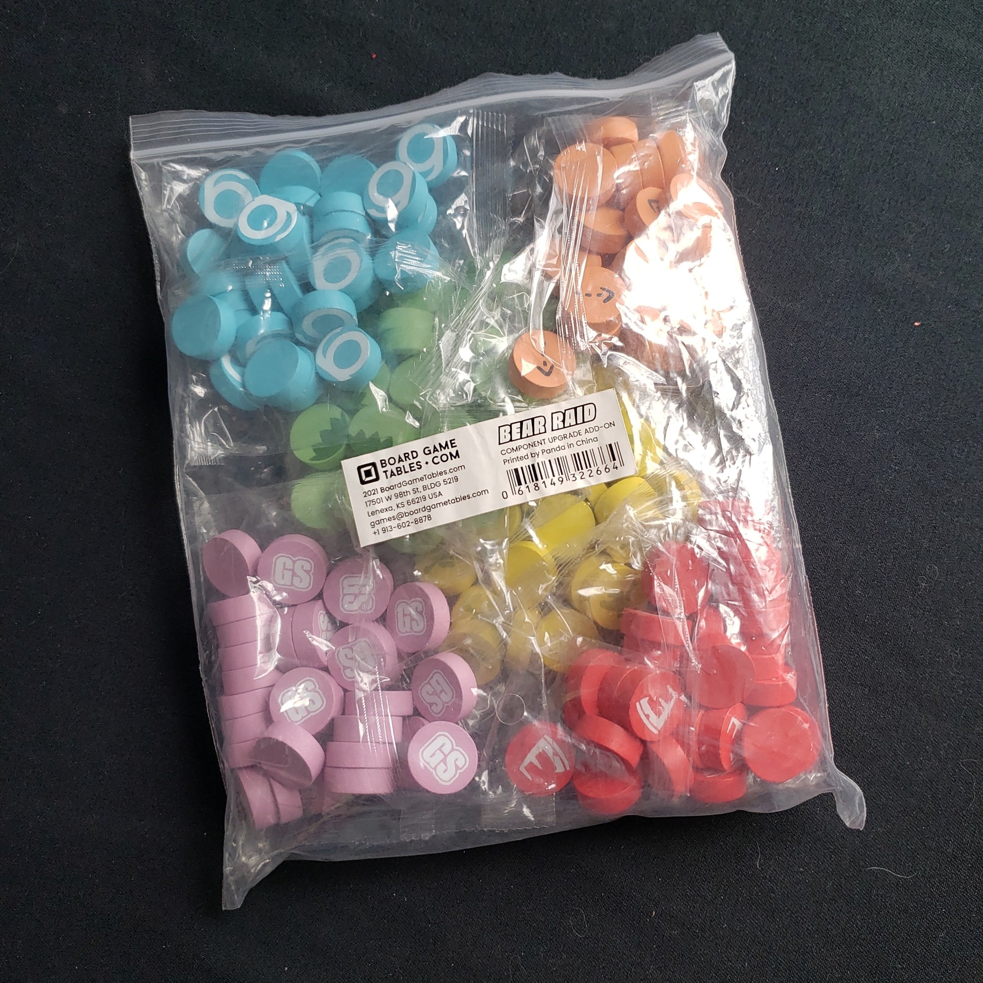 Image shows a bag of wooden upgrade discs in six colors for the Bear Raid board game
