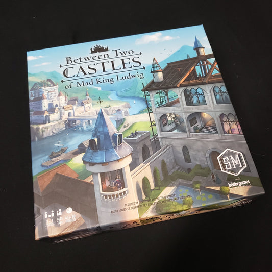 Image shows the front cover of the box of the board game Between Two Castles of Mad King Ludwig