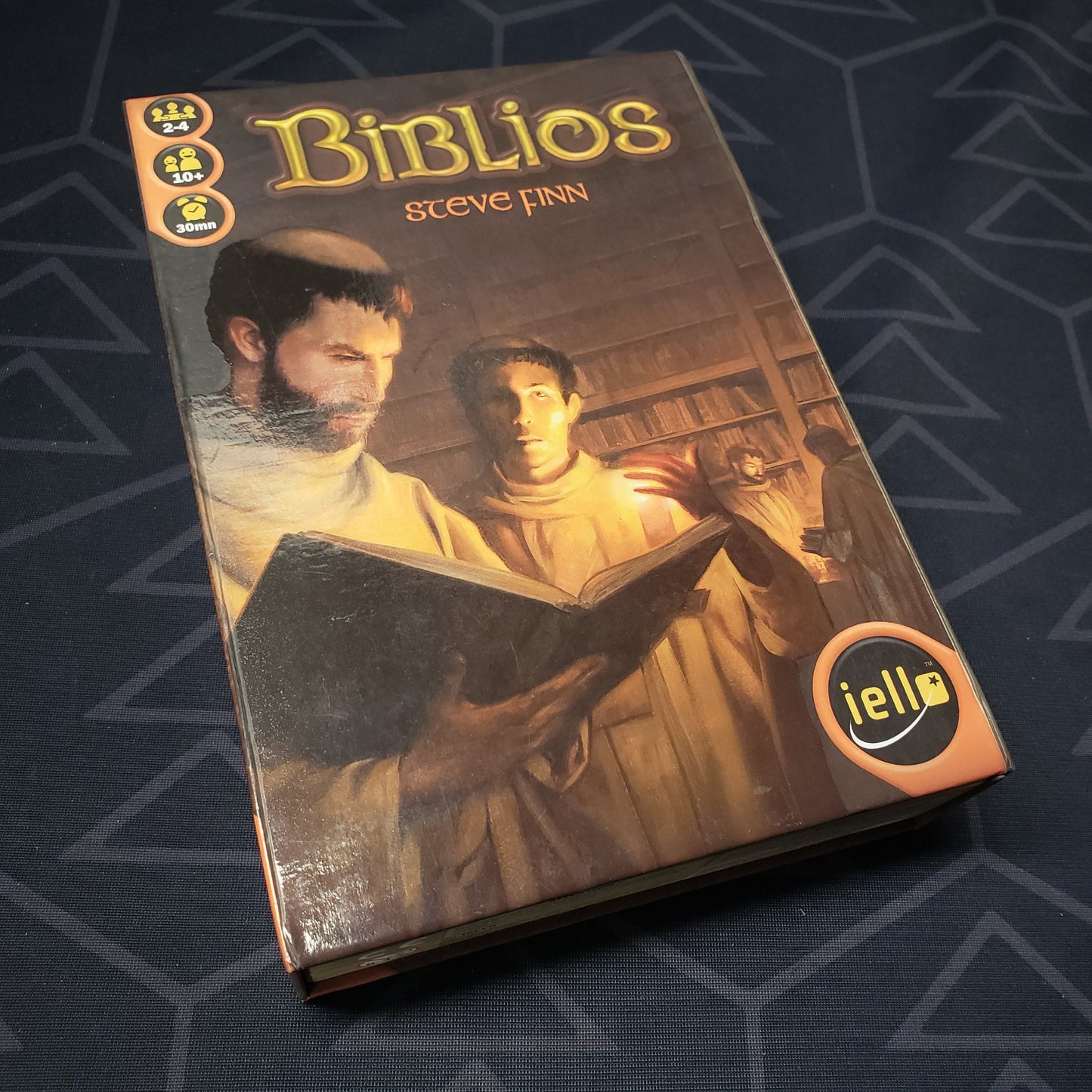 Image shows the front cover of the box of the Biblios board game