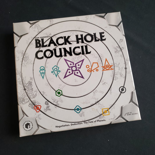 Image shows the front cover of the box of the Black Hole Council board game