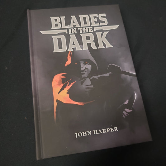 Image shows the front cover of the Blades In The Dark roleplaying game book
