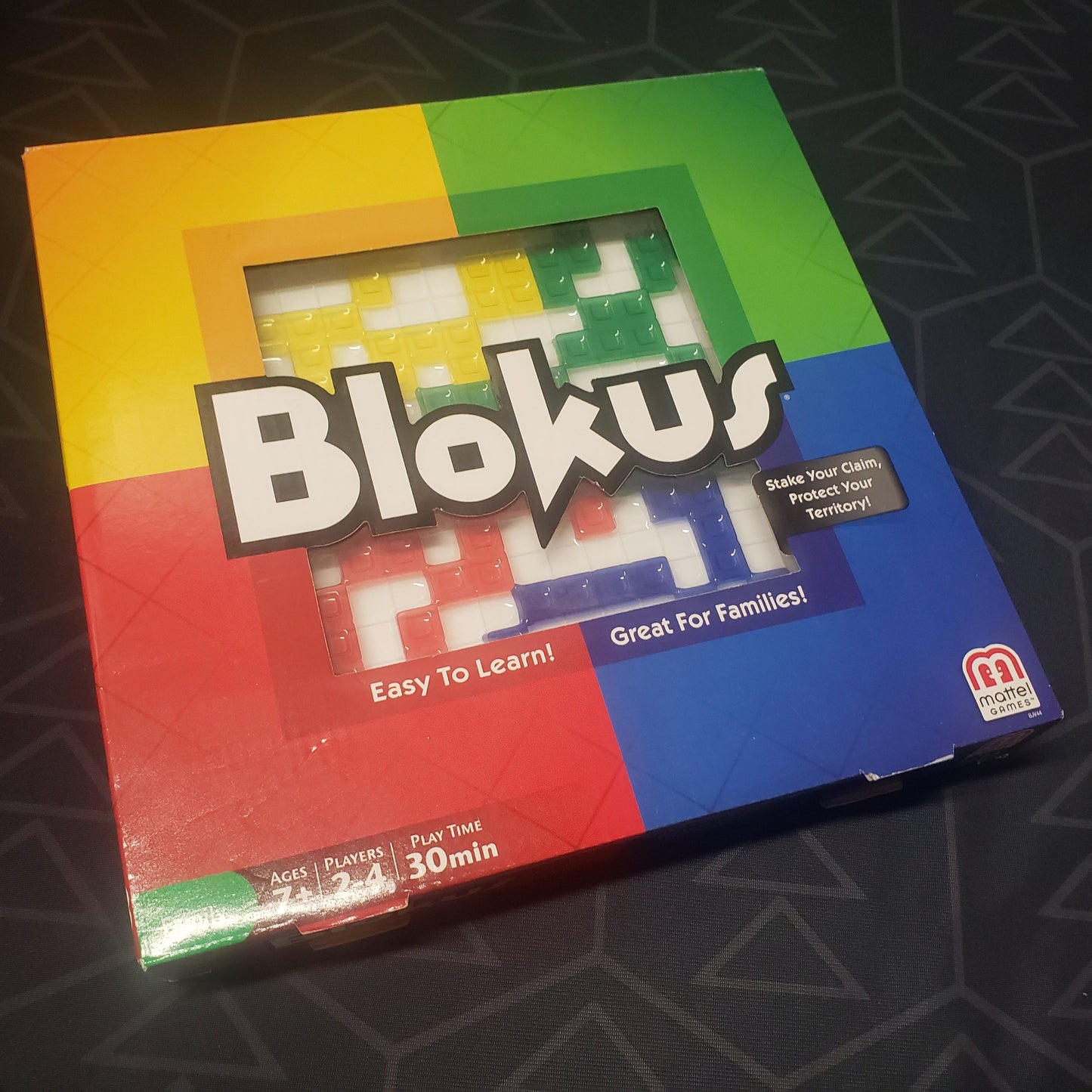 Image shows the front cover of the box for the Blokus board game