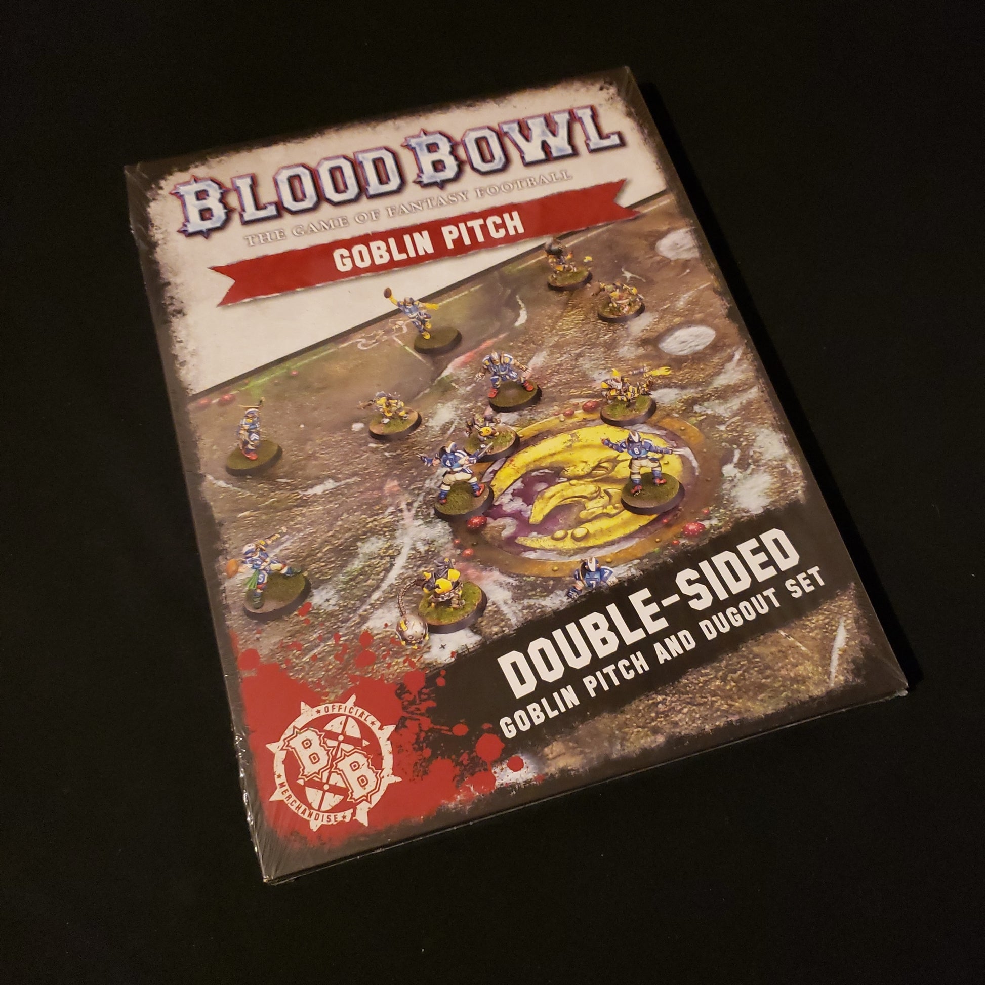 Image shows the front of the package for the Goblin Pitch & Dugout Pack for the Blood Bowl miniatures game