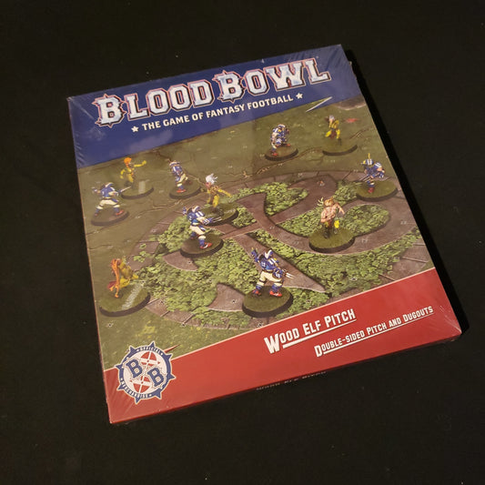 Image shows the front of the package for the Wood Elf Pitch & Dugout Pack for the Blood Bowl miniatures game