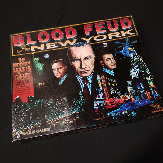 Image shows the front cover of the box of the board game Blood Feud in New York
