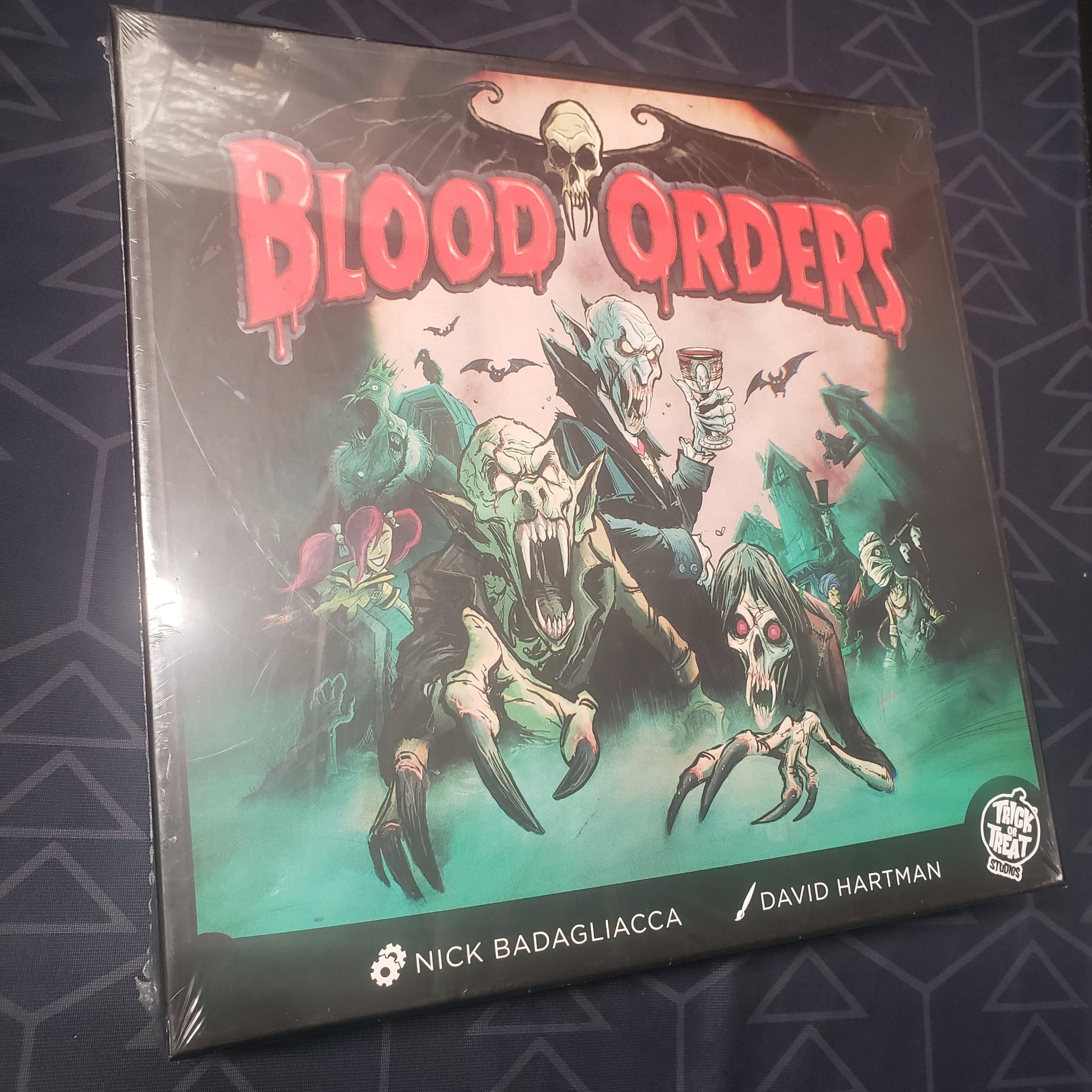 Image shows the front cover of the box for the Blood Orders board game