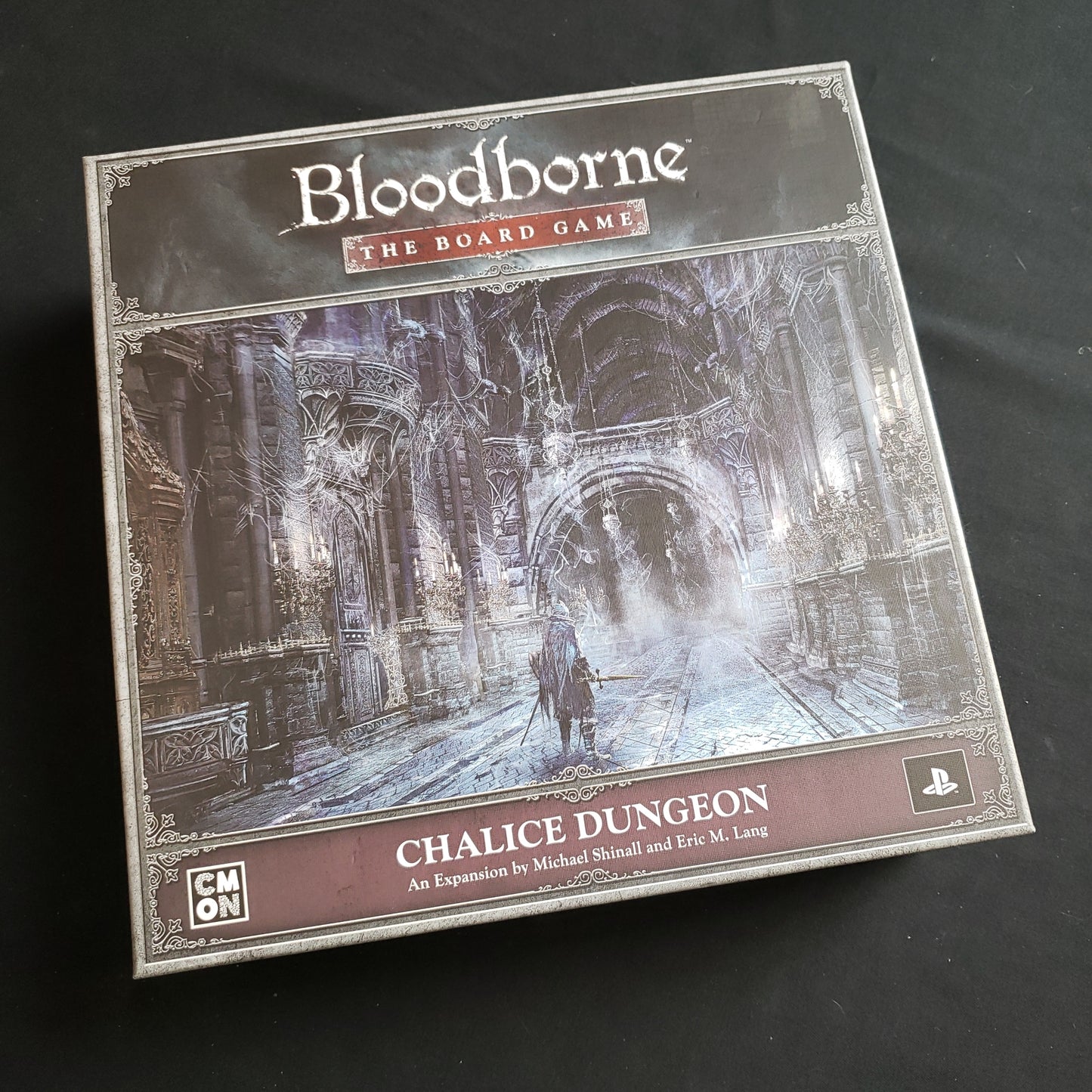 Image shows the front cover of the box of the Chalice Dungeon expansion for Bloodborne: The Board Game