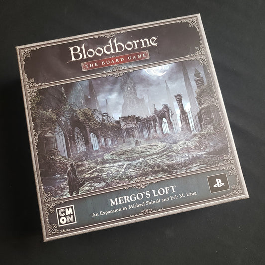 Image shows the front cover of the box of the Mergo's Loft expansion for Bloodborne: The Board Game