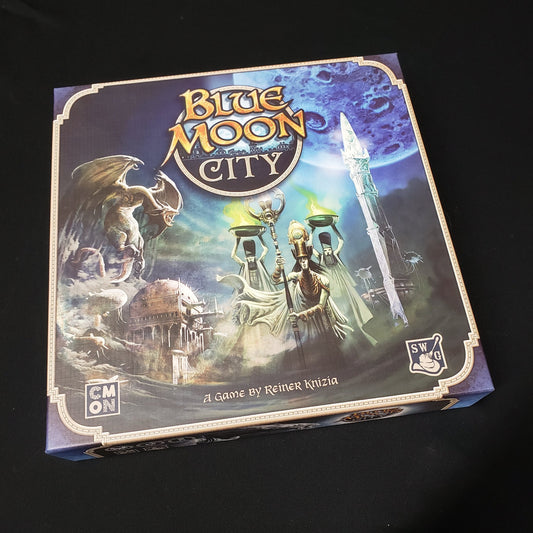 Image shows the front cover of the box of the Blue Moon City board game