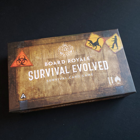 Image shows the front cover of the box of the Board Royale: Survival Evolved card game