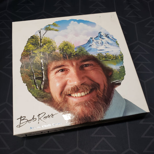 Image shows the front cover of the box for the Bob Ross: Art of Chill board game