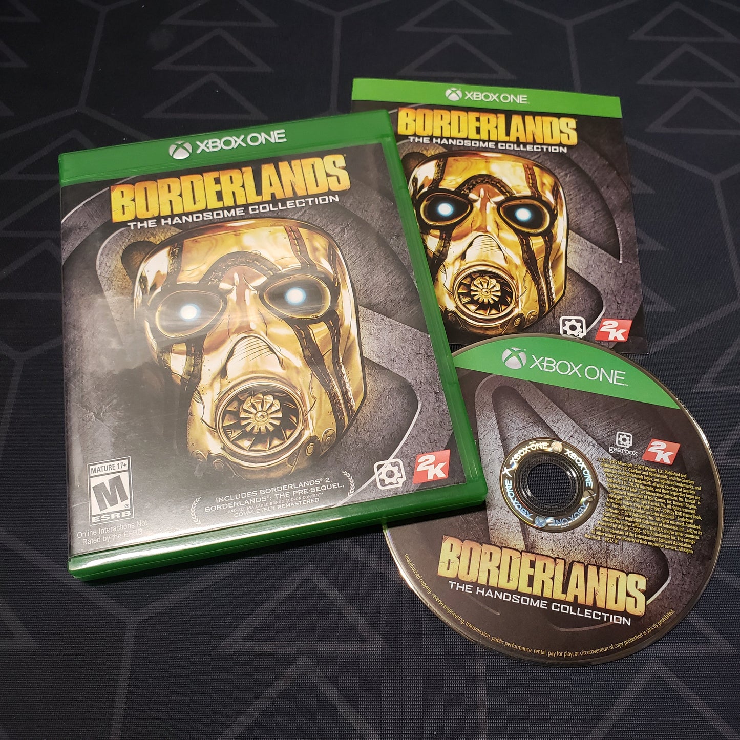 Image shows the case, manual and disc for the video game Borderlands: The Handsome Collection for Xbox One