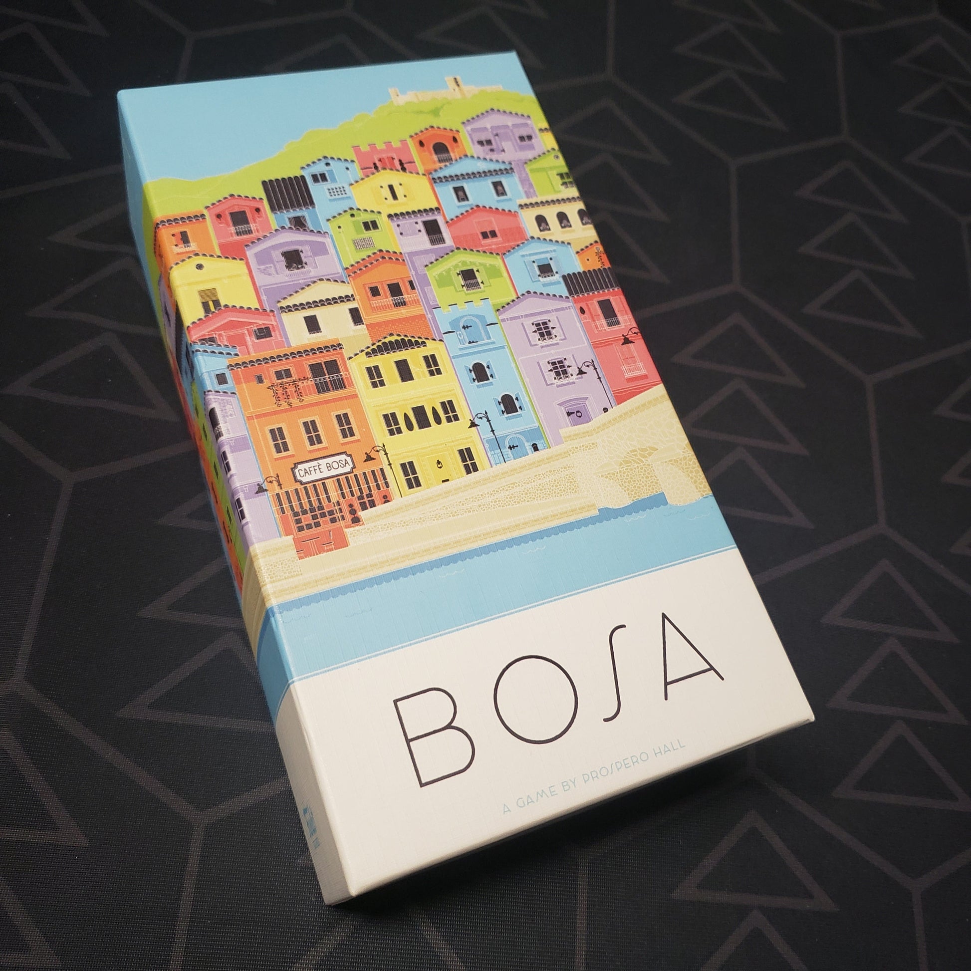 Image shows the front cover of the box for the Bosa board game