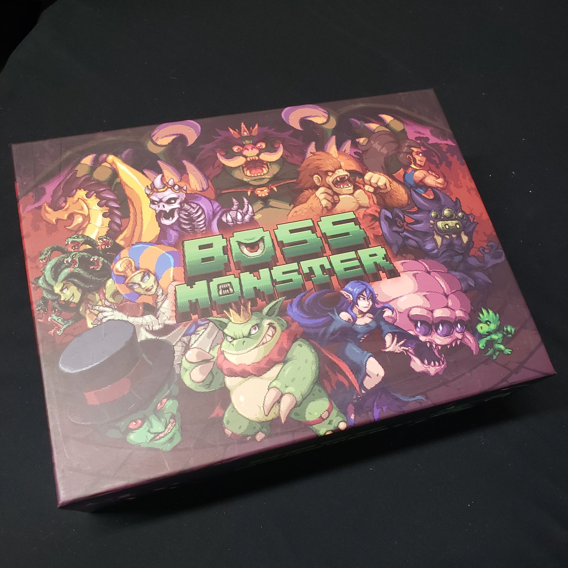 Image shows the front cover of the Big Box storage solution for the card game Boss Monster