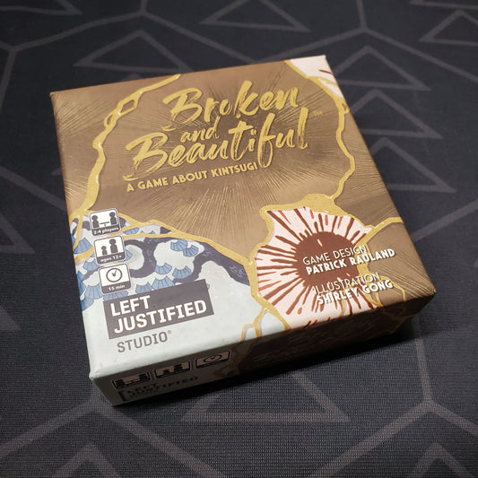 Image shows the front cover of the box for the Broken and Beautiful card game