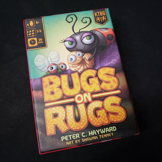 Image shows the front cover of the box of the Bugs on Rugs card game