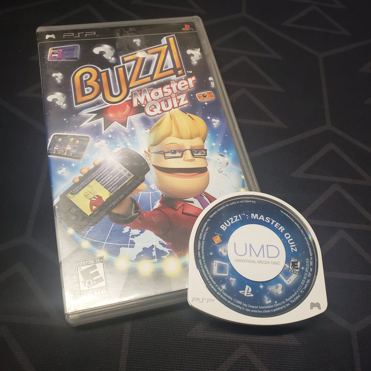 Image shows the case and UMD disc for the video game Buzz! Master Quiz for Playstation Portable