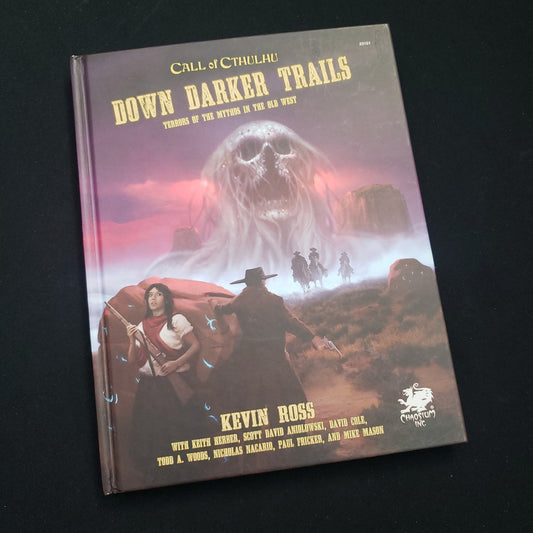 Image shows the front cover of the Down Darker Trails book for the Call of Cthulhu: Seventh Edition roleplaying game
