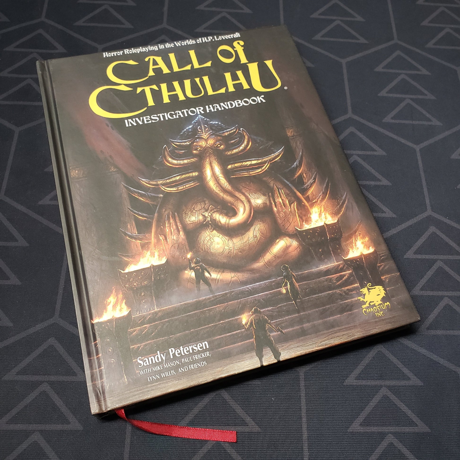 Image shows the front cover of the Investigator Handbook for the roleplaying game Call of Cthulhu 7E