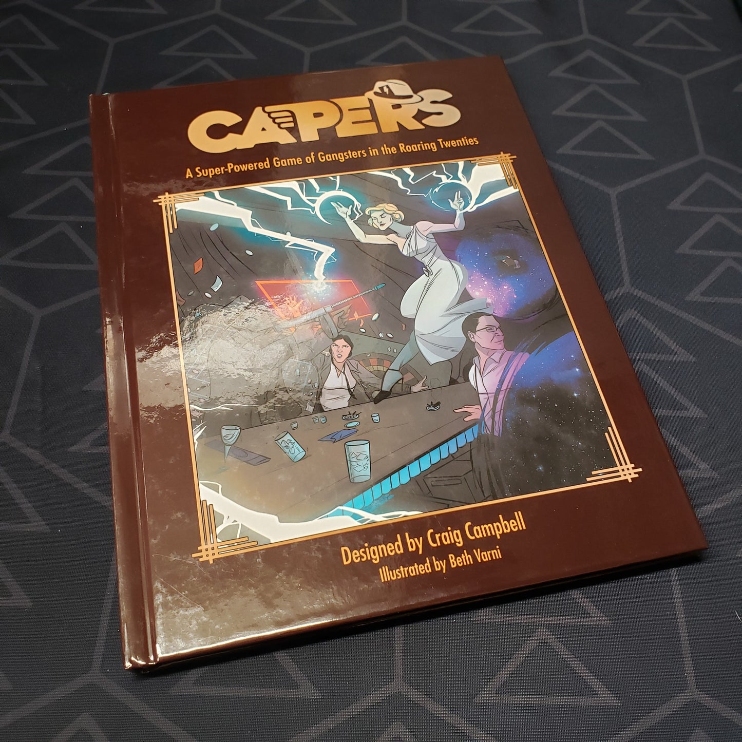 Image shows the front cover of the core rulebook for the roleplaying game CAPERS