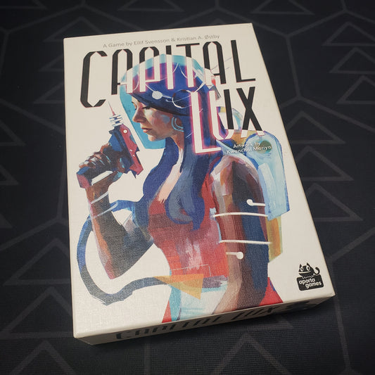 Image shows the front cover of the box for the Capital Lux card game